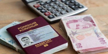 Pasaport, ehliyet ve Türk Lirası banknotları, arka planda hesap makinesi.